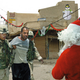 U.S. soldiers instruct an Iraqi to tell Santa what he wants for Christmas.